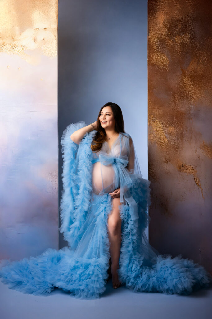 Elegant maternity portrait of an expecting mother in a flowing gown at Kimberly Cowan Photography in Midland, Texas
